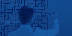 man drawing a maze on a whiteboard