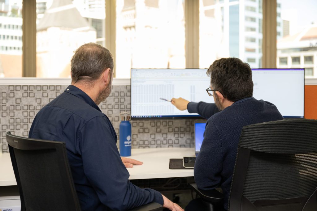 two men using a computer