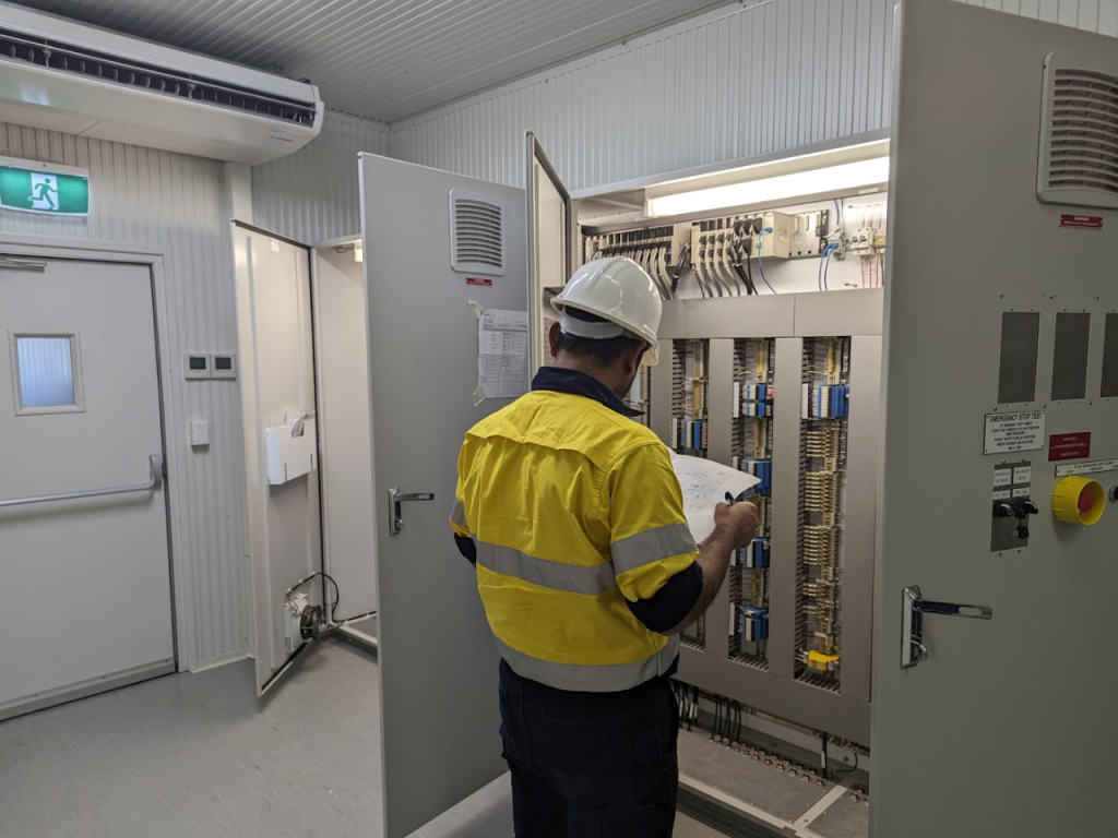 Mipac has been providing APA DPS with control system engineering support for a number of years. Here is one of them reading something from a notepad.